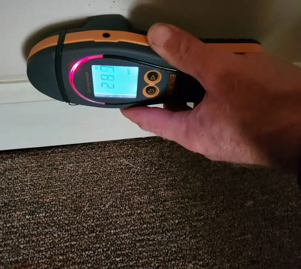 Moisture detection at baseboard during Storm Damage Restoration in Carmel